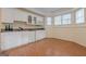 Bright kitchenette with white cabinets, granite countertops, and modern appliances at 7415 Northampton Ct, Cumming, GA 30040