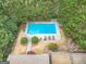 Aerial view of a private pool surrounded by lush greenery and a well-maintained pool deck with lounge chairs at 7415 Northampton Ct, Cumming, GA 30040