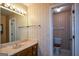 Bathroom featuring a vanity with a large mirror and an adjacent toilet room at 154 Waverly Way, Alpharetta, GA 30009
