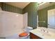 Bathroom featuring a tub, vanity, toilet, and patterned wallpaper at 154 Waverly Way, Alpharetta, GA 30009