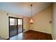 Open dining area featuring wood floors, sliding glass doors, and decorative light fixture at 154 Waverly Way, Alpharetta, GA 30009