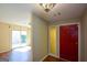 Bright foyer with decorative light fixture, hardwood floors, and entry to living spaces at 154 Waverly Way, Alpharetta, GA 30009
