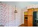 Kitchen with wood cabinets and red floral wallpaper at 154 Waverly Way, Alpharetta, GA 30009