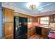 Charming kitchen features a black refrigerator and abundant wood cabinets at 154 Waverly Way, Alpharetta, GA 30009