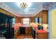 Charming kitchen featuring abundant wood cabinets, red counters, and stainless steel appliances at 154 Waverly Way, Alpharetta, GA 30009
