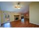 Spacious living room with vaulted ceiling, stone fireplace, fan and sliding glass door at 154 Waverly Way, Alpharetta, GA 30009