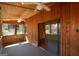 Enclosed sunroom featuring wood paneling, ceiling fans, and sliding glass doors leading to the outside at 154 Waverly Way, Alpharetta, GA 30009
