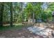 Picture of the backyard area featuring a stone patio and a partial view of the wooded surroundings at 204 Mitchell Rd, Fayetteville, GA 30214