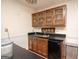 Cozy bar area features dark countertops, wood cabinets, and a mini-refrigerator at 204 Mitchell Rd, Fayetteville, GA 30214