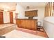 A bar with wood paneling, cabinets and a display case is situated between the foyer and living room at 204 Mitchell Rd, Fayetteville, GA 30214