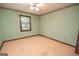 Small bedroom featuring a ceiling fan, window, and hardwood flooring at 204 Mitchell Rd, Fayetteville, GA 30214