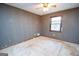 Small bedroom with a single window featuring security bars at 204 Mitchell Rd, Fayetteville, GA 30214