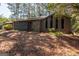 Charming home with a combination of stone and wood siding and a lush natural front yard landscape at 204 Mitchell Rd, Fayetteville, GA 30214