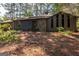 Charming home with a combination of stone and wood siding and a lush natural front yard landscape at 204 Mitchell Rd, Fayetteville, GA 30214