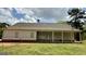 Spacious backyard featuring a covered porch, level lawn, and mature trees at 4529 Jersey Covington Rd, Covington, GA 30014