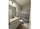 Full bathroom with single vanity, granite counters, shower and tub combination at 4529 Jersey Covington Rd, Covington, GA 30014
