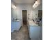 Bright bathroom features double vanity, granite countertop, tile floors, and walk-in closet access at 4529 Jersey Covington Rd, Covington, GA 30014