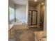 Spacious bathroom boasts a soaking tub, separate shower, granite counters, and tile flooring at 4529 Jersey Covington Rd, Covington, GA 30014
