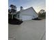 Single-story home with attached garage, clean white siding, and mature landscaping at 4529 Jersey Covington Rd, Covington, GA 30014