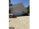 Attached two-car garage with a concrete driveway and exterior light gray siding at 4529 Jersey Covington Rd, Covington, GA 30014