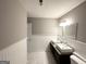 Bright bathroom featuring double sinks, white wainscotting, and neutral gray walls at 3729 Glenwood Rd, Decatur, GA 30032