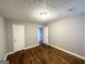A well-lit bedroom featuring hardwood floors, white doors, and neutral gray walls at 3729 Glenwood Rd, Decatur, GA 30032