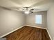 A bright bedroom with wood floors, ceiling fan, and a window with blinds at 3729 Glenwood Rd, Decatur, GA 30032