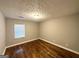 Comfortable bedroom with hardwood floors, featuring a large window and neutral paint for a serene atmosphere at 3729 Glenwood Rd, Decatur, GA 30032