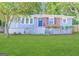 Charming single-story home with well-manicured lawn, blue siding, and brick accents offers great curb appeal at 3729 Glenwood Rd, Decatur, GA 30032