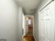 Hallway featuring gray walls, white trim and doors, and wood-look floors at 3729 Glenwood Rd, Decatur, GA 30032