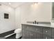 Modern bathroom with a tiled walk-in shower and a gray vanity with granite countertop at 2695 Peeler Rd, Doraville, GA 30360