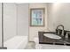 Stylish bathroom with white subway tile, black and white tiled floors, and sleek vanity at 2695 Peeler Rd, Doraville, GA 30360
