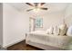 Comfortable bedroom featuring a ceiling fan and a large window that provides natural light at 2695 Peeler Rd, Doraville, GA 30360