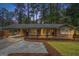 Charming brick home featuring a welcoming front porch, light blue shutters and a covered carport at 2695 Peeler Rd, Doraville, GA 30360