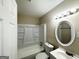 Bright bathroom with a tub-shower combo and round mirror, offering a clean and functional space at 4250 Timber Valley Ct, Decatur, GA 30032