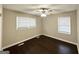 A cozy bedroom with dark wood flooring and a ceiling fan provides comfortable living space at 4250 Timber Valley Ct, Decatur, GA 30032