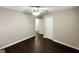 Bedroom with neutral walls, dark wood flooring, ceiling fan, and white doors at 4250 Timber Valley Ct, Decatur, GA 30032