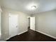 Bedroom features neutral colored walls, dark wood flooring, and white doors at 4250 Timber Valley Ct, Decatur, GA 30032