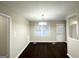 Bright dining room with dark wood flooring, a chandelier, and large windows offering natural light at 4250 Timber Valley Ct, Decatur, GA 30032
