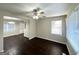 A bright living room with dark hardwood floors, a ceiling fan, and large windows that let in natural light at 4250 Timber Valley Ct, Decatur, GA 30032