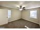 This bedroom is equipped with two windows and a ceiling fan at 4992 Needle Knob Ct, Lithonia, GA 30038