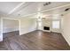 Spacious living room boasts a ceiling fan, fireplace, and new vinyl flooring at 4992 Needle Knob Ct, Lithonia, GA 30038