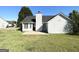 Backyard featuring a well-maintained lawn, patio, and white siding at 210 Huntington Dr, Mcdonough, GA 30253