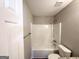 Clean bathroom featuring a shower and tub combo, toilet and light gray walls at 210 Huntington Dr, Mcdonough, GA 30253