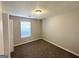 Carpeted bedroom featuring light walls, a window, and a white door at 210 Huntington Dr, Mcdonough, GA 30253