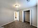 Bedroom with carpet, closet, and adjoining bathroom with gray walls at 210 Huntington Dr, Mcdonough, GA 30253