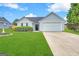 Charming single-story home with a well-maintained lawn and a two-car garage at 210 Huntington Dr, Mcdonough, GA 30253