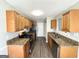 Functional kitchen with granite countertops, wooden cabinets and stainless steel appliances at 210 Huntington Dr, Mcdonough, GA 30253