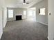 Spacious living room with fireplace, neutral paint, large windows and a ceiling fan at 210 Huntington Dr, Mcdonough, GA 30253