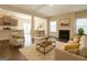 Open-concept living room with fireplace, dining area, and modern furnishings at 1735 Labonte Pkwy, Mcdonough, GA 30253